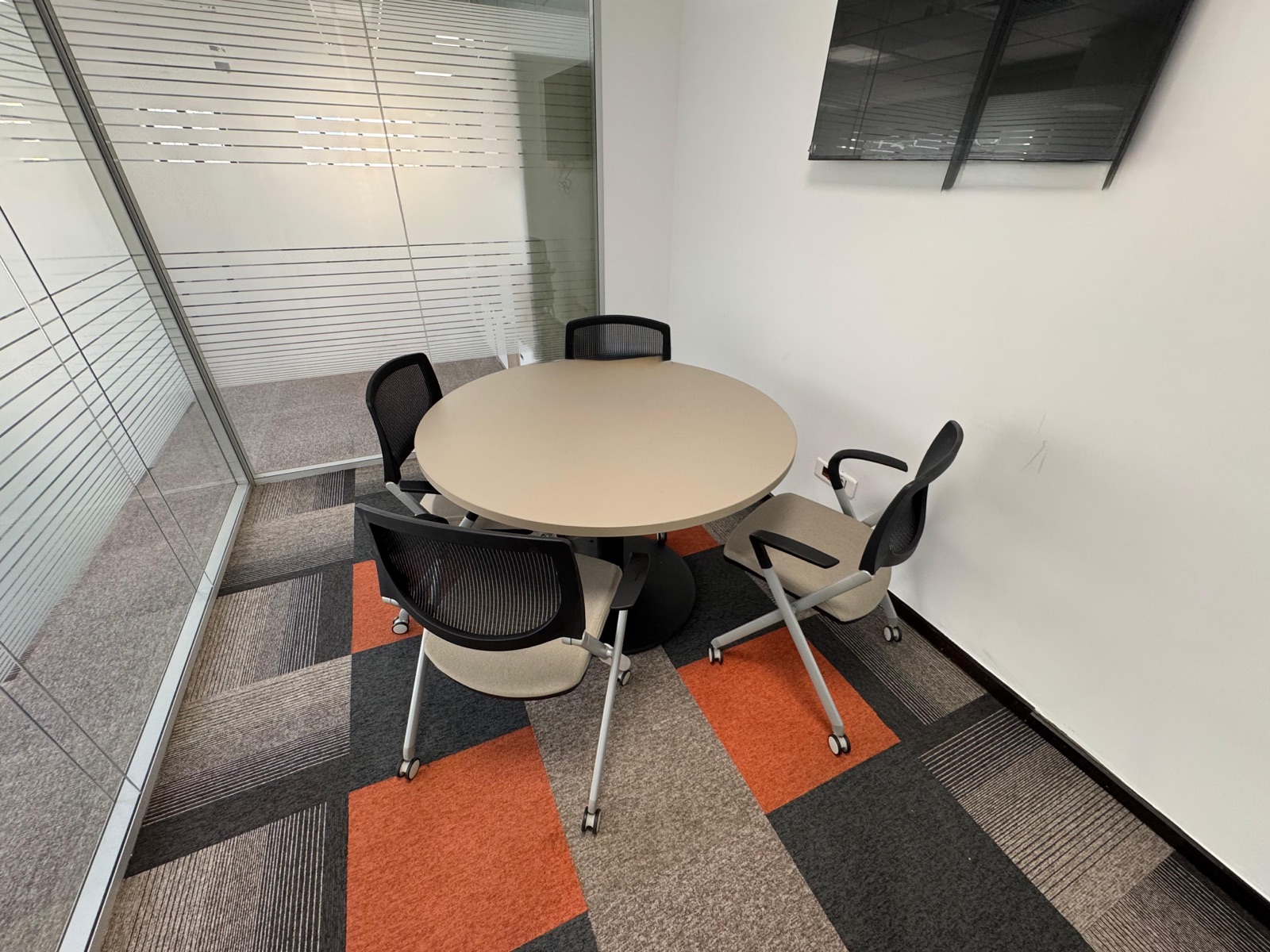 Nexus, a CoZone meeting room with a round table and screen